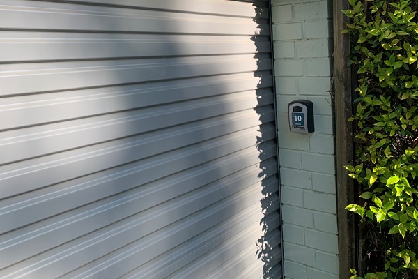Lock-up garage with EV charger & remote controlled door.