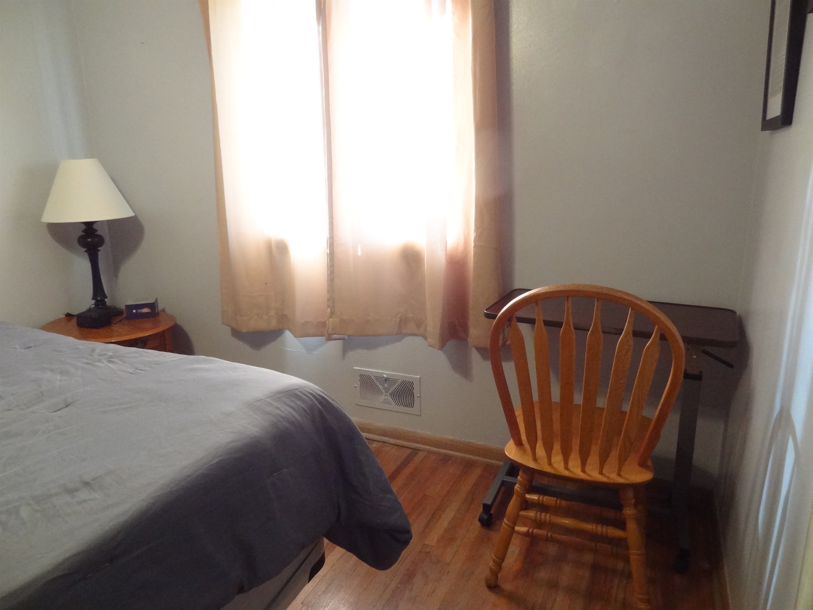 Master bedroom with queen bed, Roku smart TV, dresser, ceiling fan, and desk