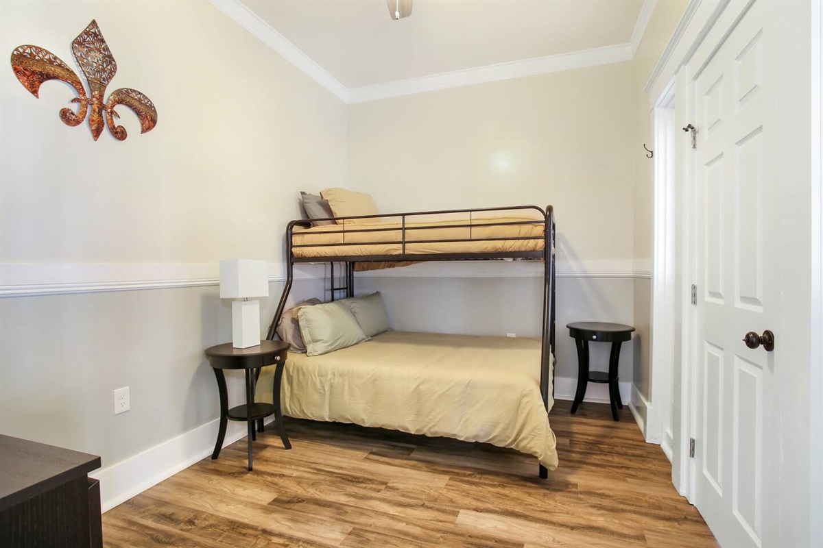 Bedroom 4. 1 twin over 1 full bunk bed, dresser, connecting door to bedroom 5. Not pictured: Roku TV.