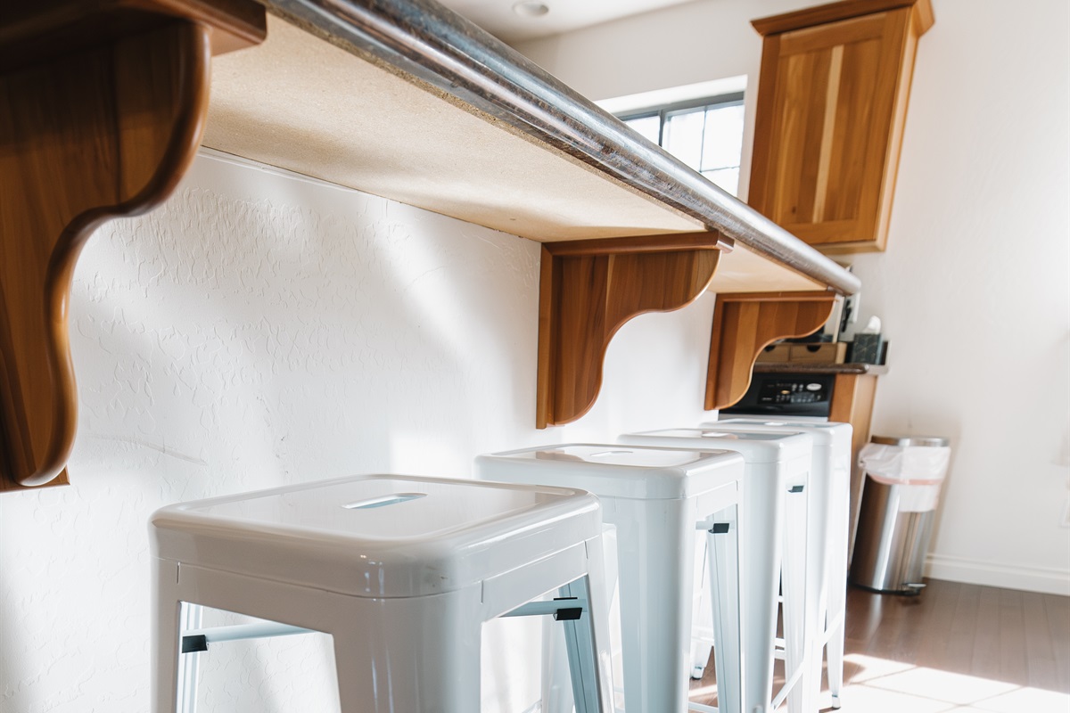 Kitchen bar seating with four stools—perfect for morning coffee, casual meals, or gathering together after a day of hiking, skiing, or lake fun in Pinetop.