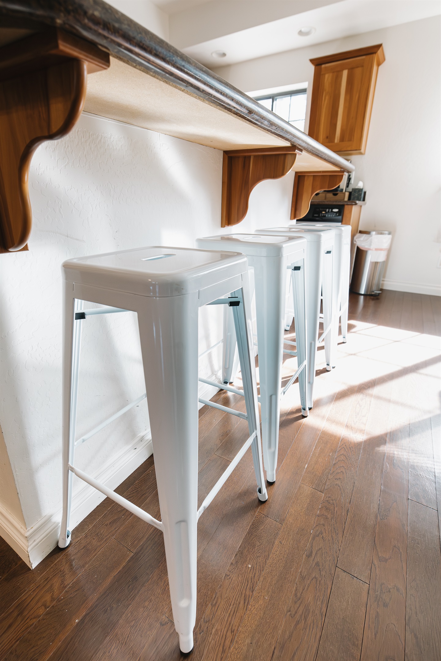 Kitchen bar seating with four stools—perfect for morning coffee, casual meals, or gathering together after a day of hiking, skiing, or lake fun in Pinetop.