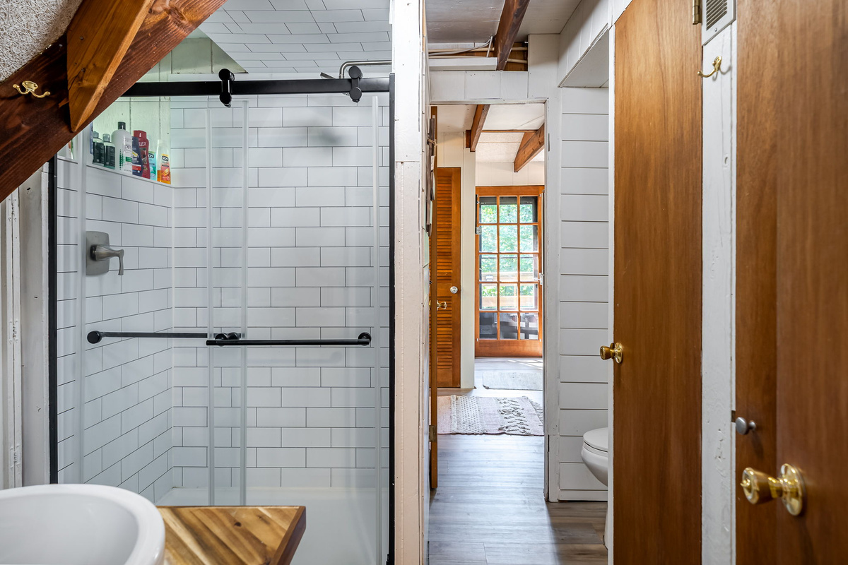 Step into the walk-in glass shower and take your time — the barn door hardware and open layout make it feel like a private spa.