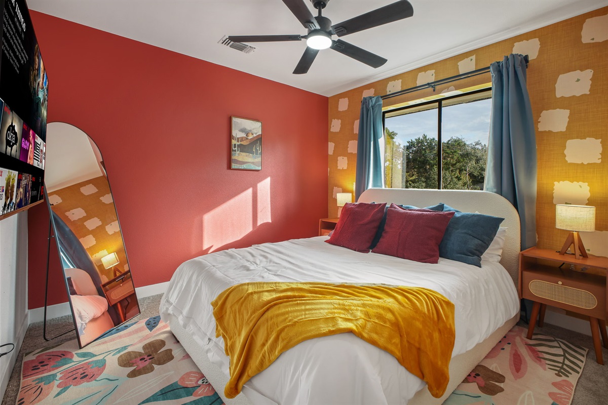 Bedroom 3: Cozy queen bedroom with plush bedding, Smart TV, and full-length mirror.
