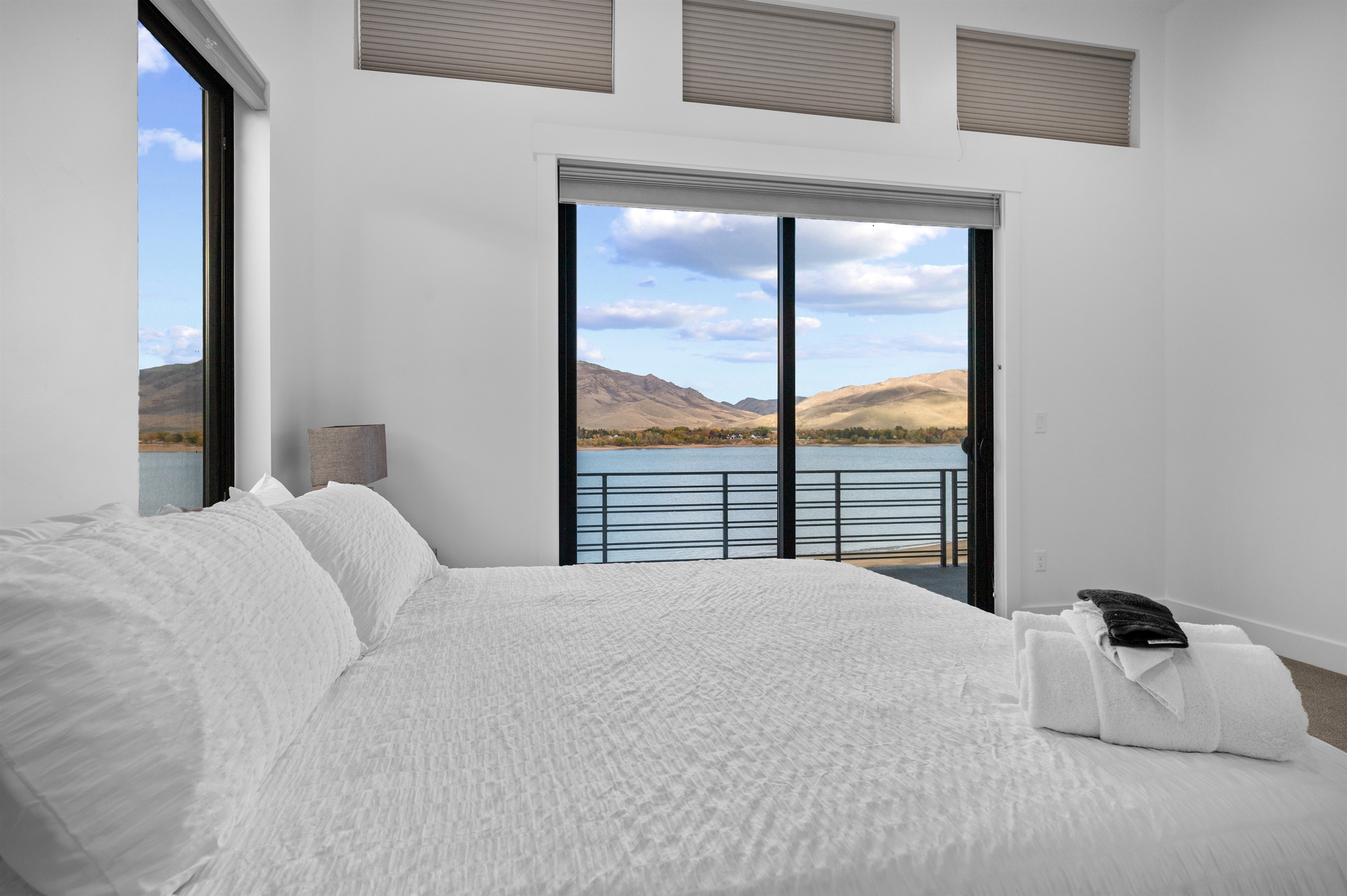 King suite offering serene lake and mountain views from the upper level.