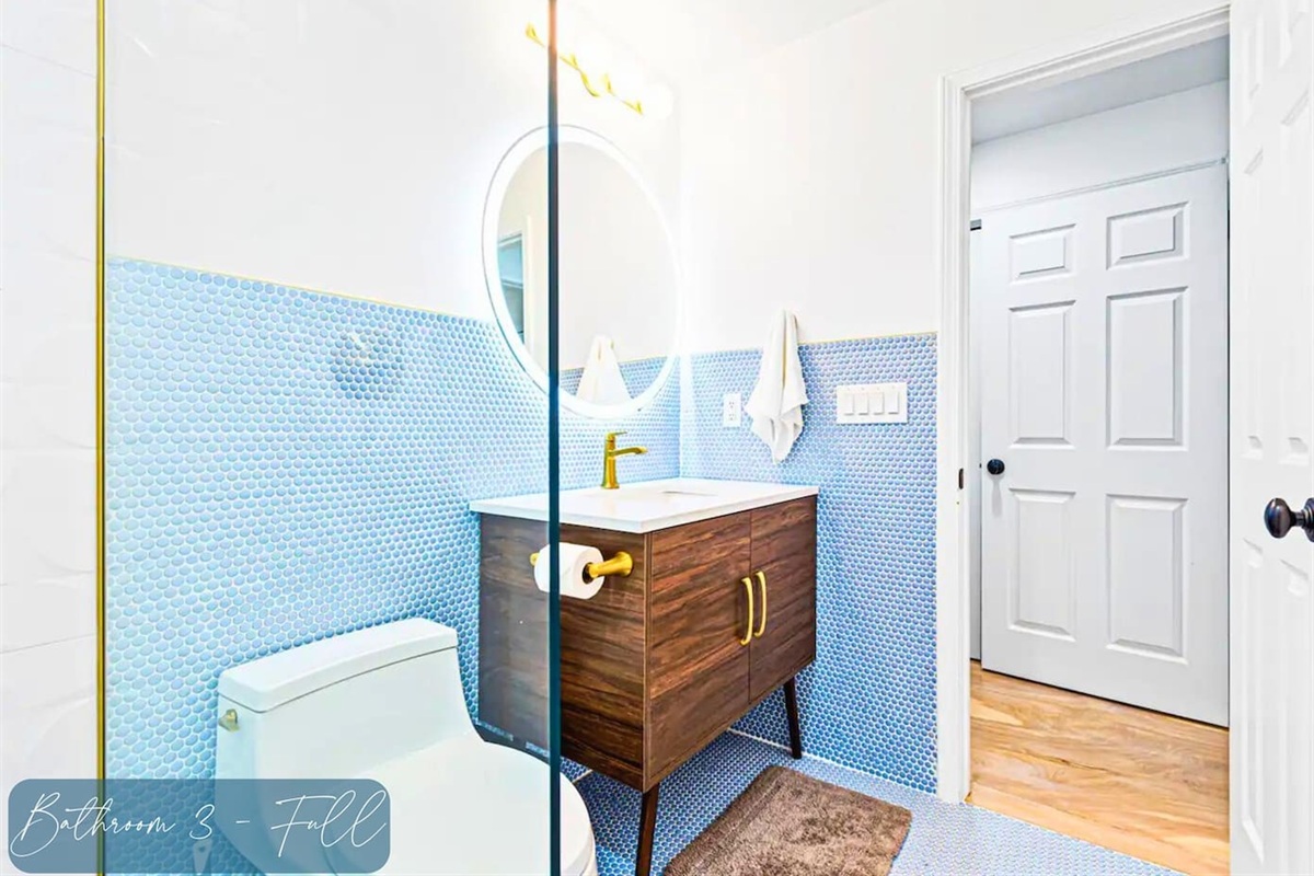 Upstairs Bathroom with Beautiful Blue Tile Accents and Walk-In Shower and Anti-Fog Mirror