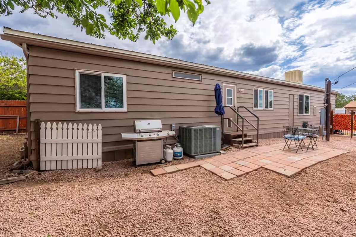 Relax, play, and dine together in this spacious, welcoming backyard.