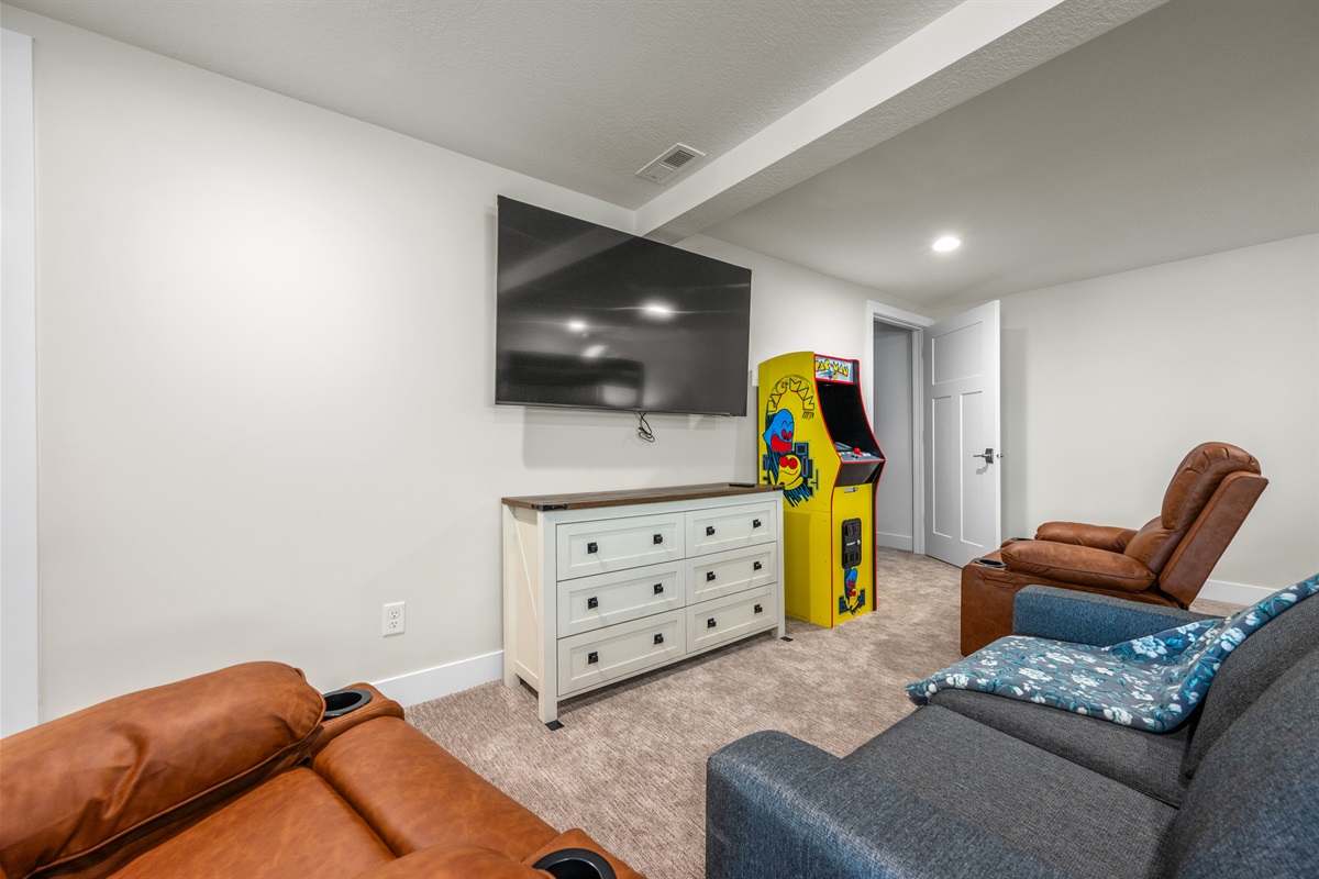 This bunkroom also has PAC Man and a soft, TV, and two recliners.