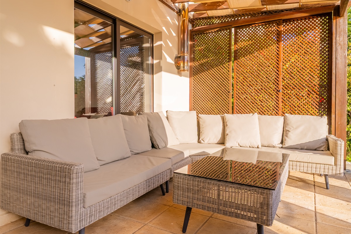 Unwind in the spacious sofa beneath the wooden pergola – a perfect spot for to share stories of the day's adventures or pick up a book from our little library.
