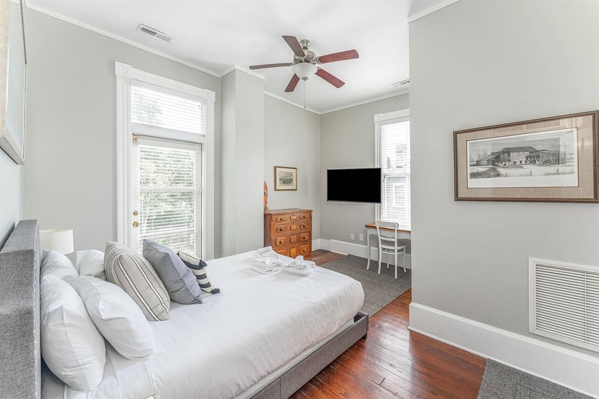 Spacious bedroom with views of both the backyard/pool as well as the side of the home provides plenty of natural light throughout the day.