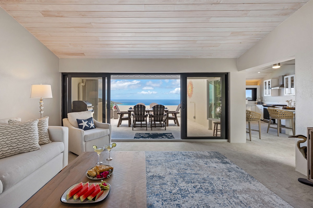 Walk through the sliding doors to a sun-filled balcony with view of Hans Lollick