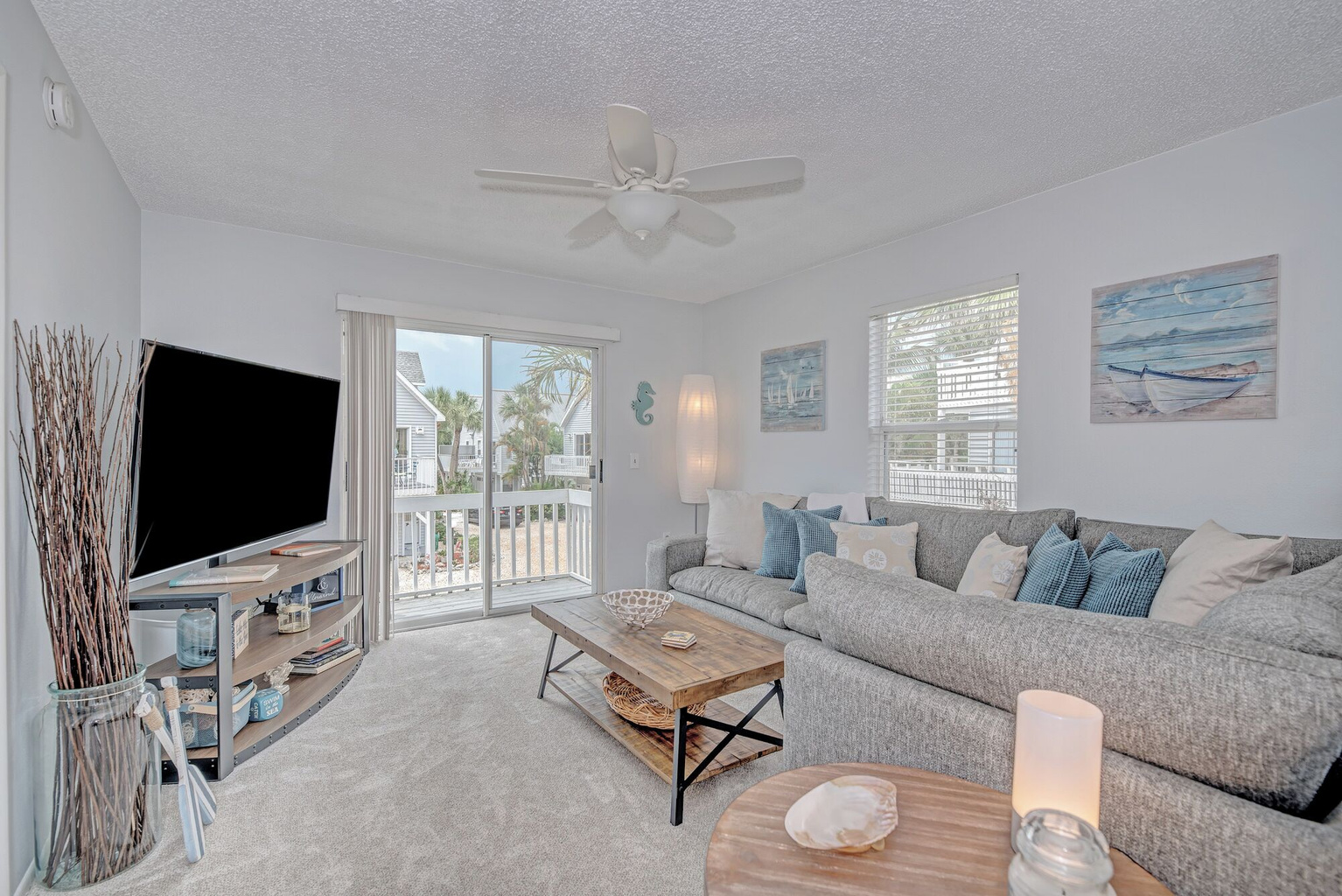 Open, airy layout with comfy seating, smart TV and outdoor front deck area. 