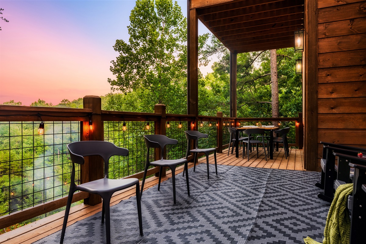Dine on the back deck with string lights and nature views