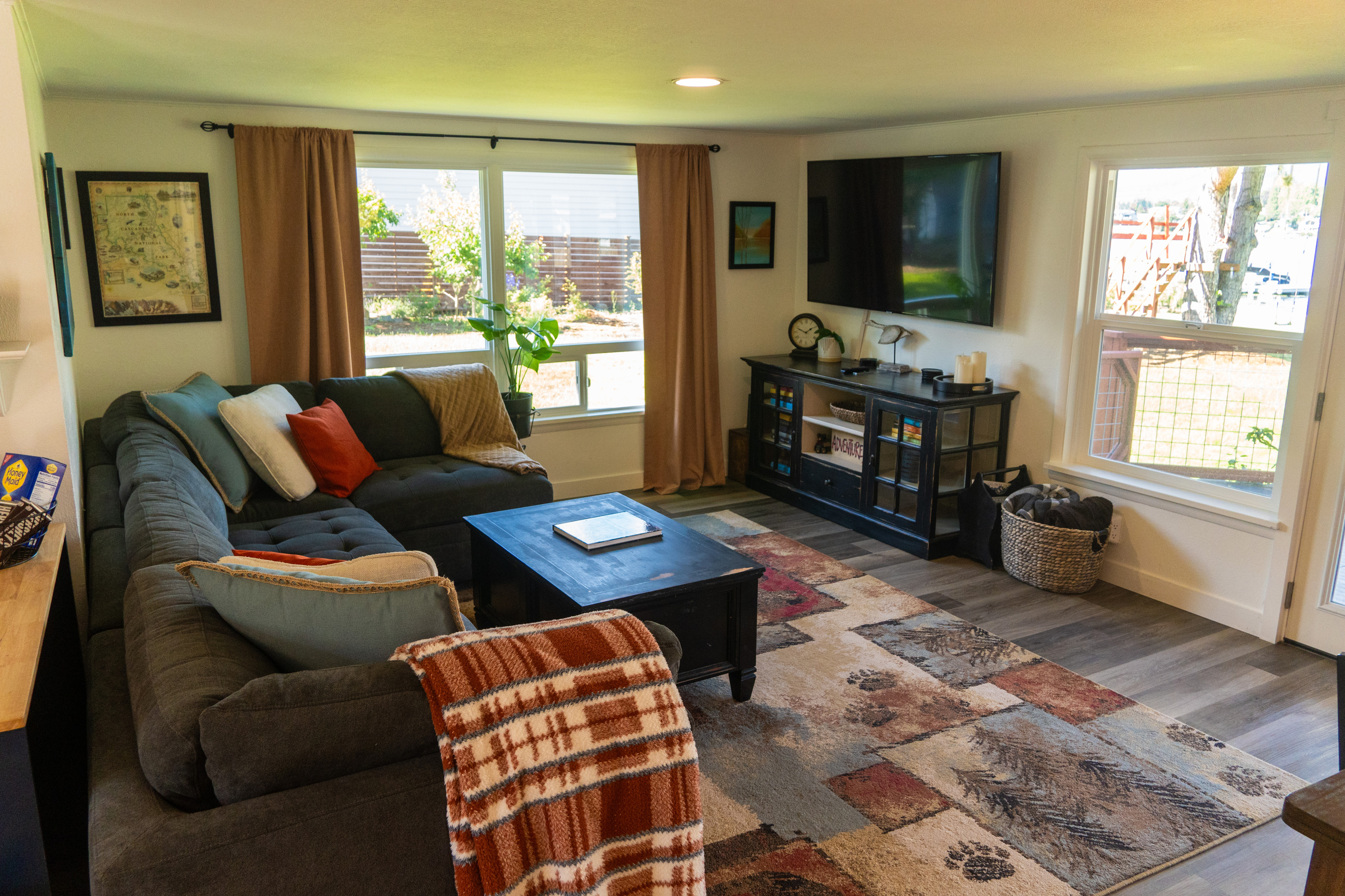 A cozy living space with a TV, where the view stretches across the lake, bringing calm and connection to the room.
