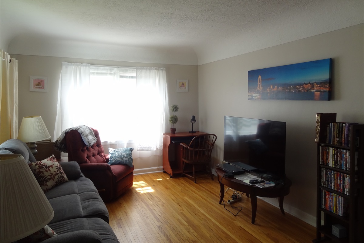 Living room with couch, recliners, and Roku smart TV