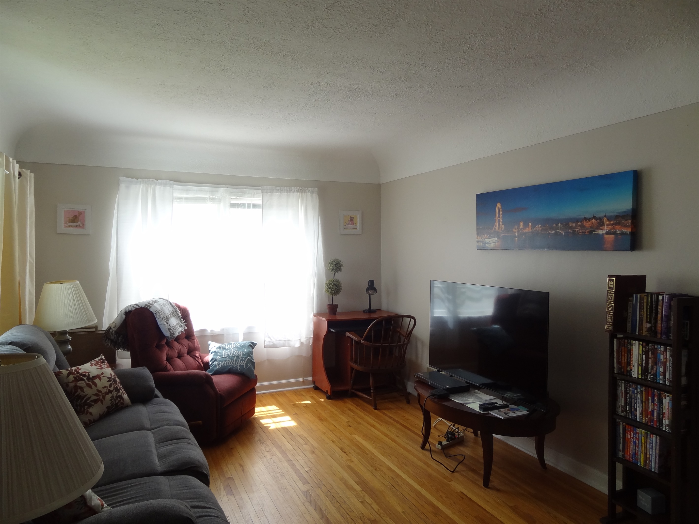Living room with couch, recliners, and Roku smart TV