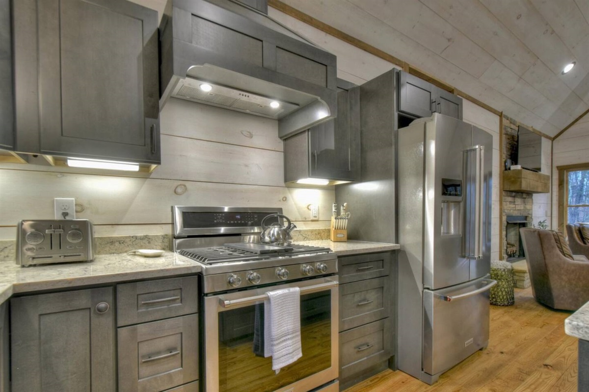 New stainless steel kitchen appliances in a well stocked kitchen for cooking.
