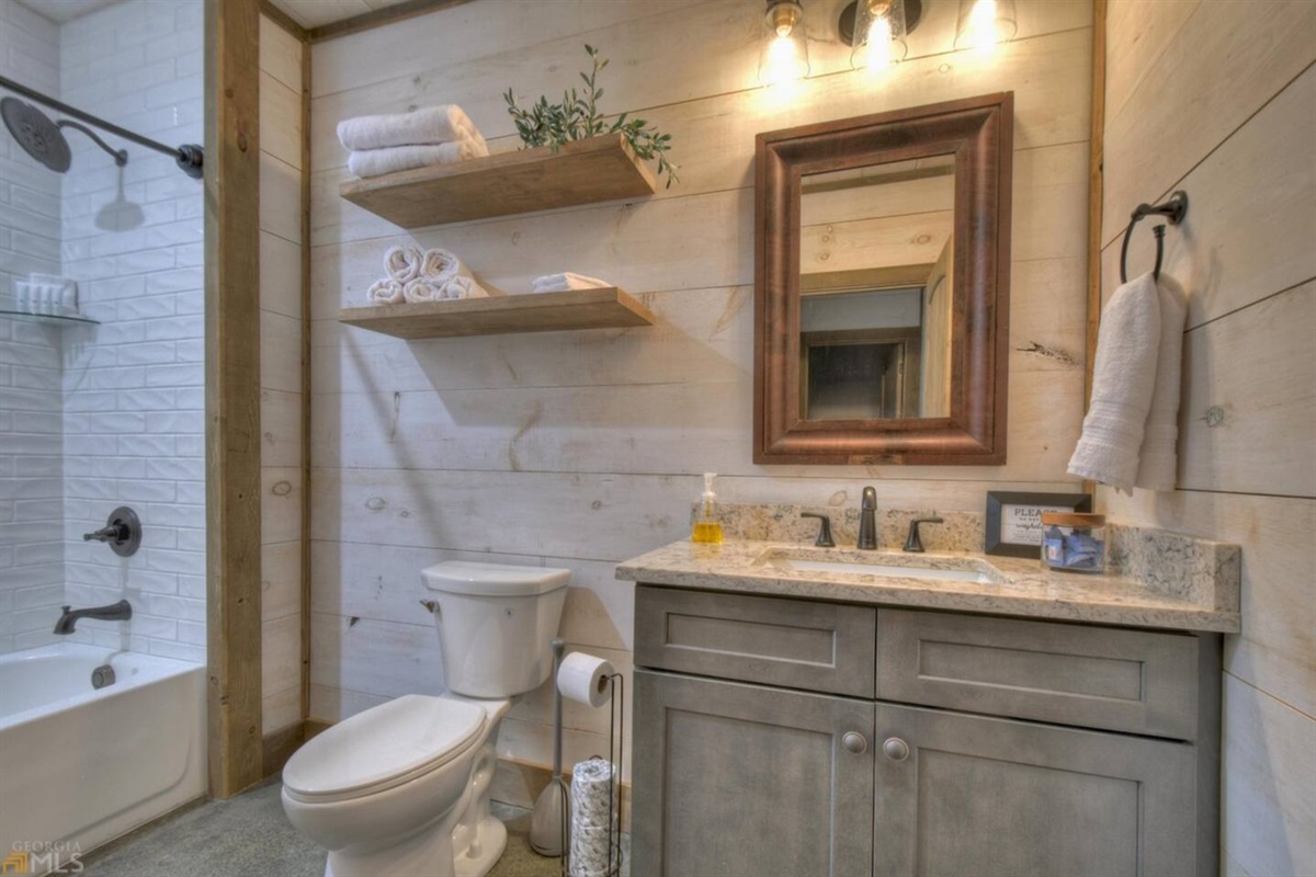 Lower level bathroom. Towels, hand towels, wash clothes, make up wipes, make up towels provided.  Shampoo, conditioner, and body wash also provided.