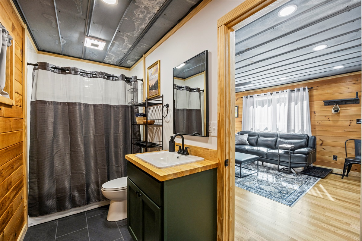First bathroom with modern fixtures and a tub/shower combo.