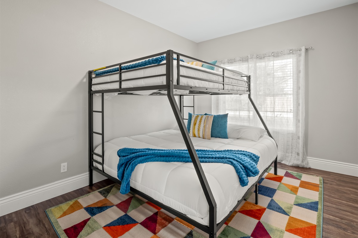 Fun and functional bunk room featuring a queen bed on the bottom and twin on top—perfect for kids, teens, or extra guests. Bright, comfortable, and designed for restful nights after a full day of fun.