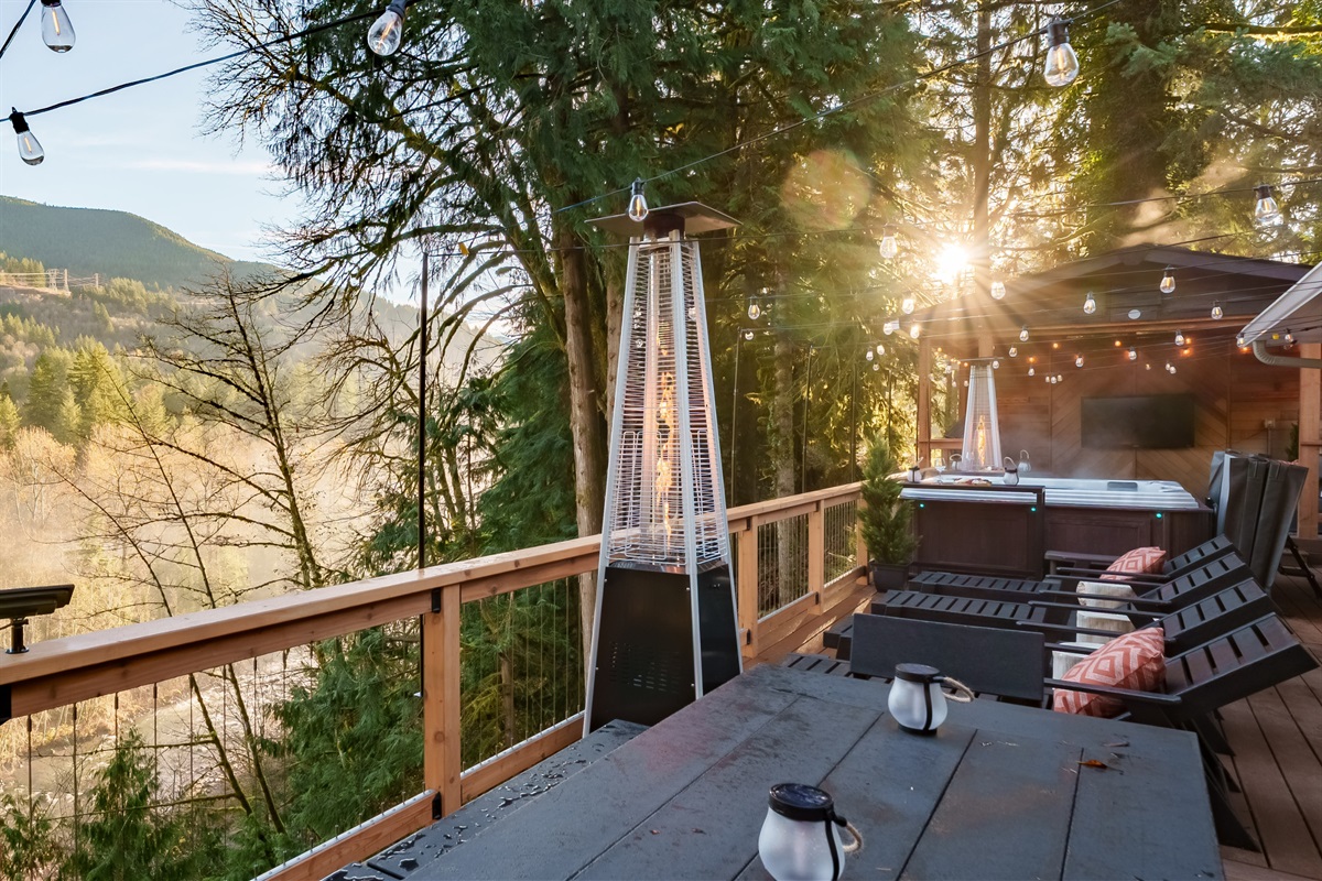 A perfect morning view: glowing sunlight, river mist, and endless forest scenery enjoyed from the comfort of the deck with heaters and lounge seating.