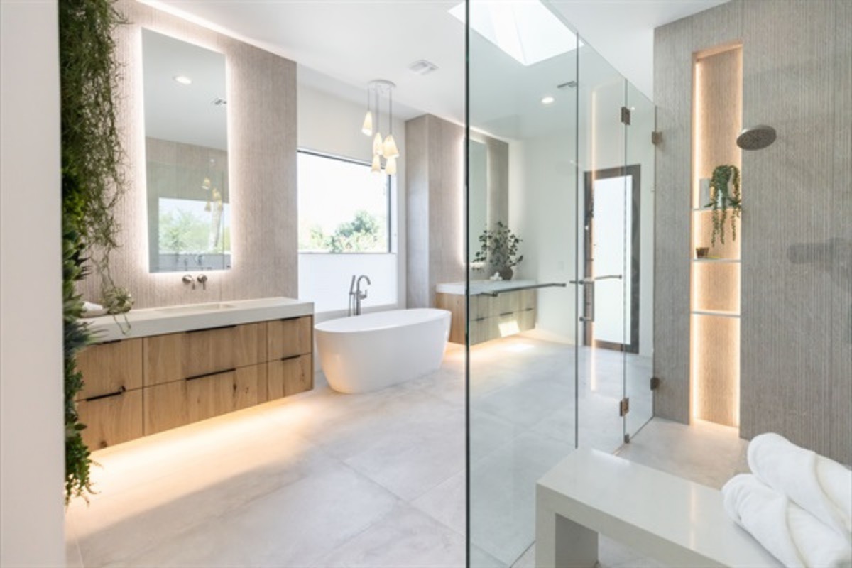 Primary ensuite with double vanities, tub, and walk in shower.