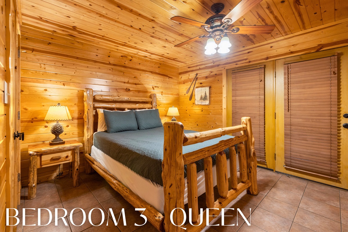 Bedroom with wood bedframe and cozy cabin atmosphere.