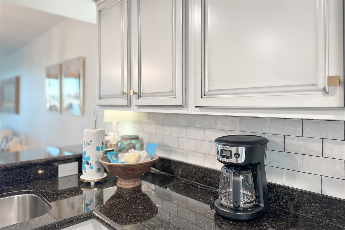 Modern kitchen essentials at your fingertips. This countertop setup offers everything you need for a quick breakfast or a relaxing cup of coffee.