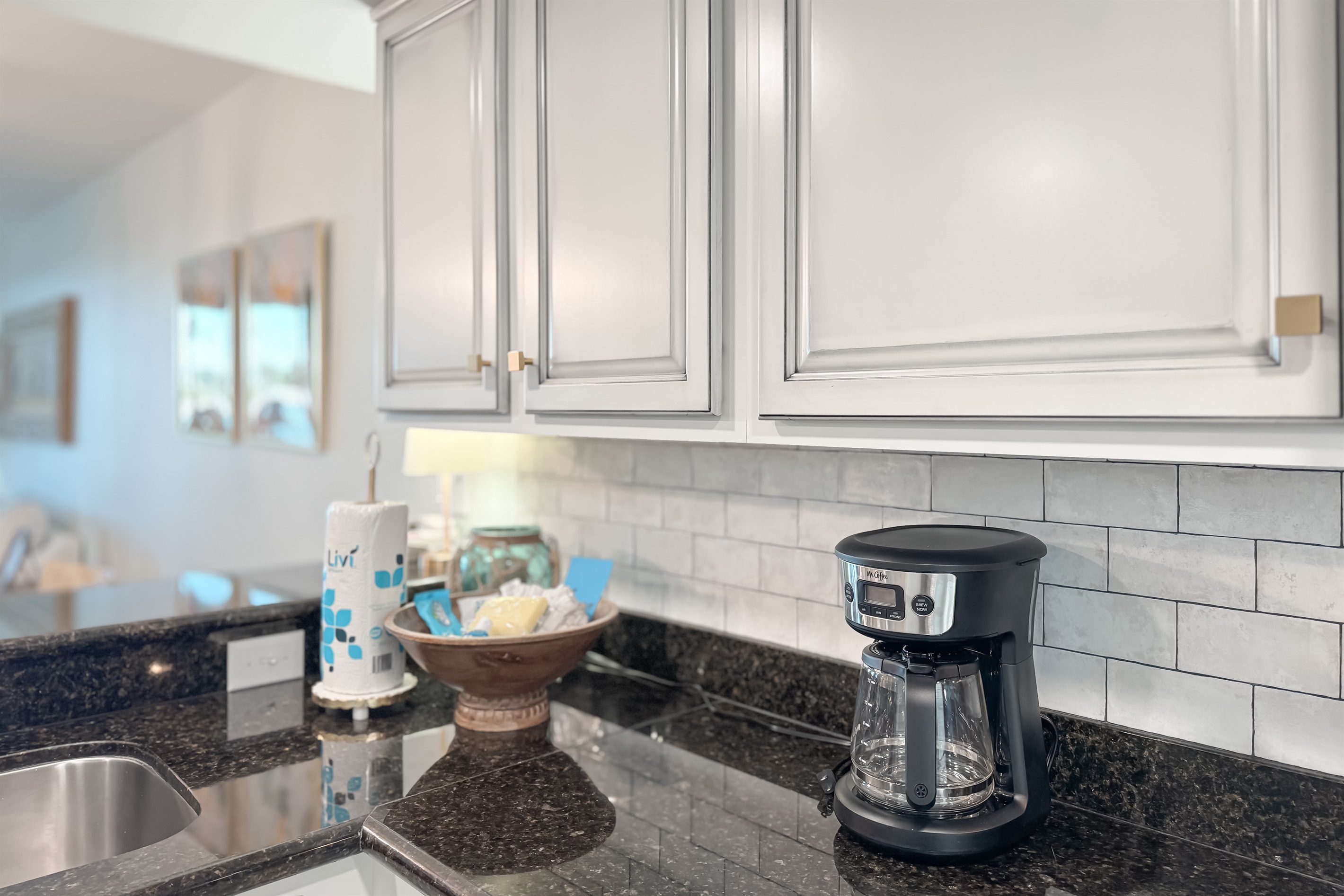 Modern kitchen essentials at your fingertips. This countertop setup offers everything you need for a quick breakfast or a relaxing cup of coffee.