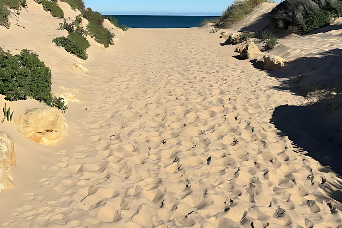 A sandy track winds through the coastal dunes to the Indian Ocean at Preston Beach, part of the long, open coastline running alongside Yalgorup National Park in Western Australia.