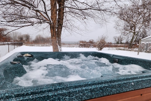 Relax in the private hot tub with a view of Lake Muskegon