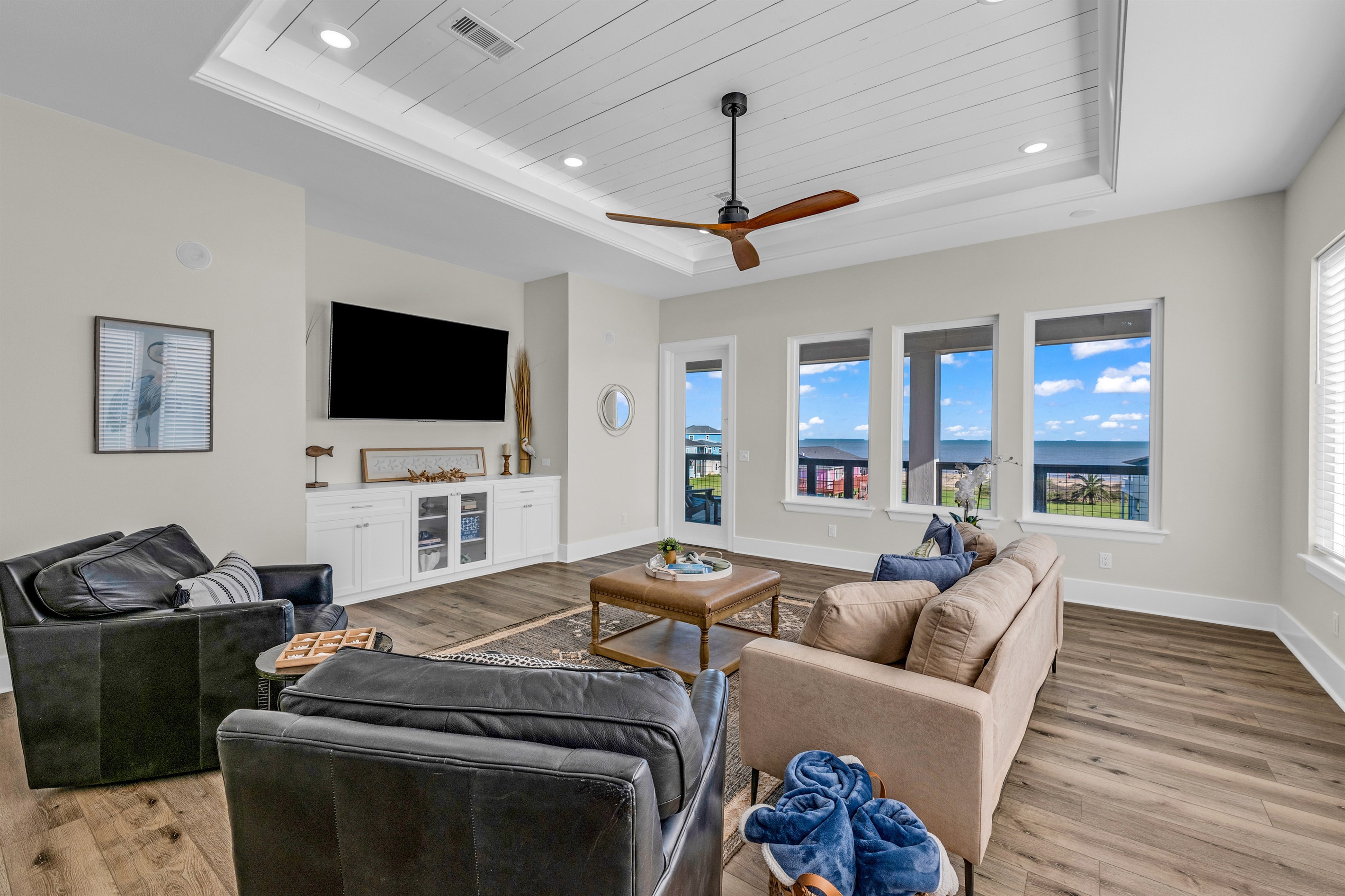 Costa Cristal Media Room: A well-lit media room featuring a smart TV and ocean vistas, offering a perfect blend of comfort and convenience for movie nights or relaxing afternoons.