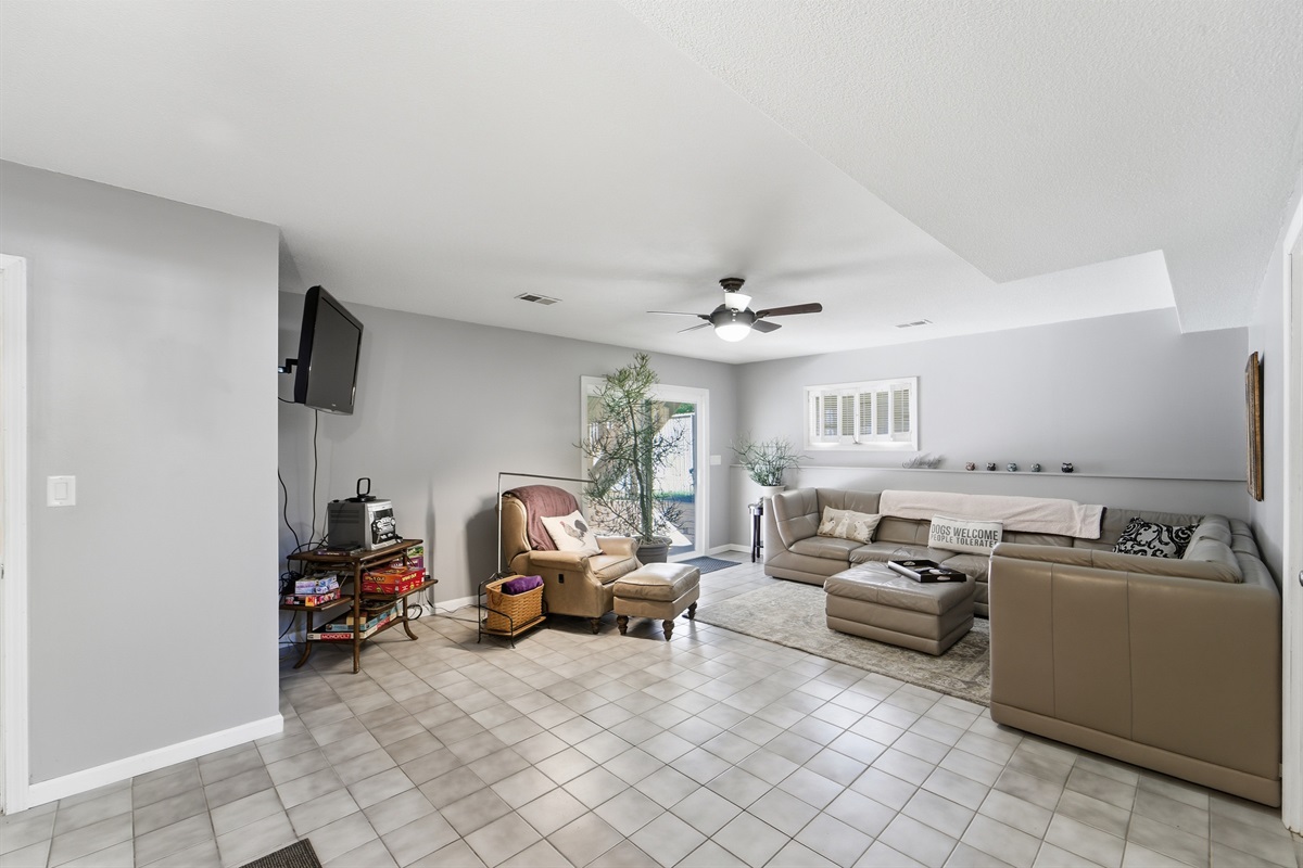 The basement living room has an oversized sectional with plenty of boardgames and puzzles, the family can gather to have a fun night in.