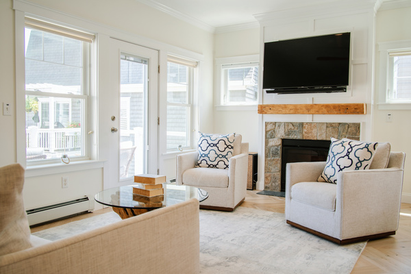 Natural light, comfortable seating, and a cozy fireplace create an inviting space to unwind.