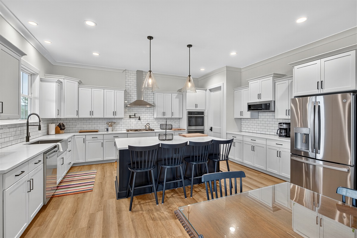 Beautiful and bright kitchen with breakfast bar seating and views of the lake—perfect for morning coffee or evening snacks.