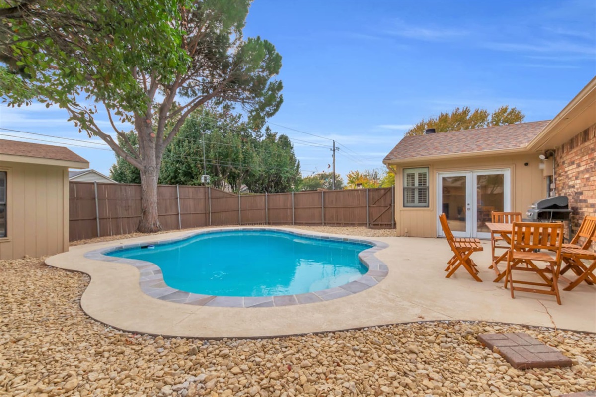 Expansive backyard featuring a private pool, BBQ grill, and outdoor dining area—your own secluded retreat.