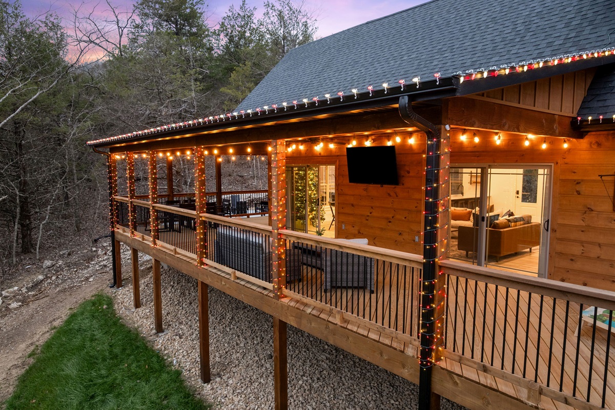 Covered deck with string lights for cozy nights outside.