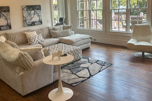 Sophisticated living room designed for comfort and style. Space features high-end furnishings.
Large windows fill the room with natural light. Cozy fireplace add to the ambiance, making it the perfect setting for relaxation or entertaining guest