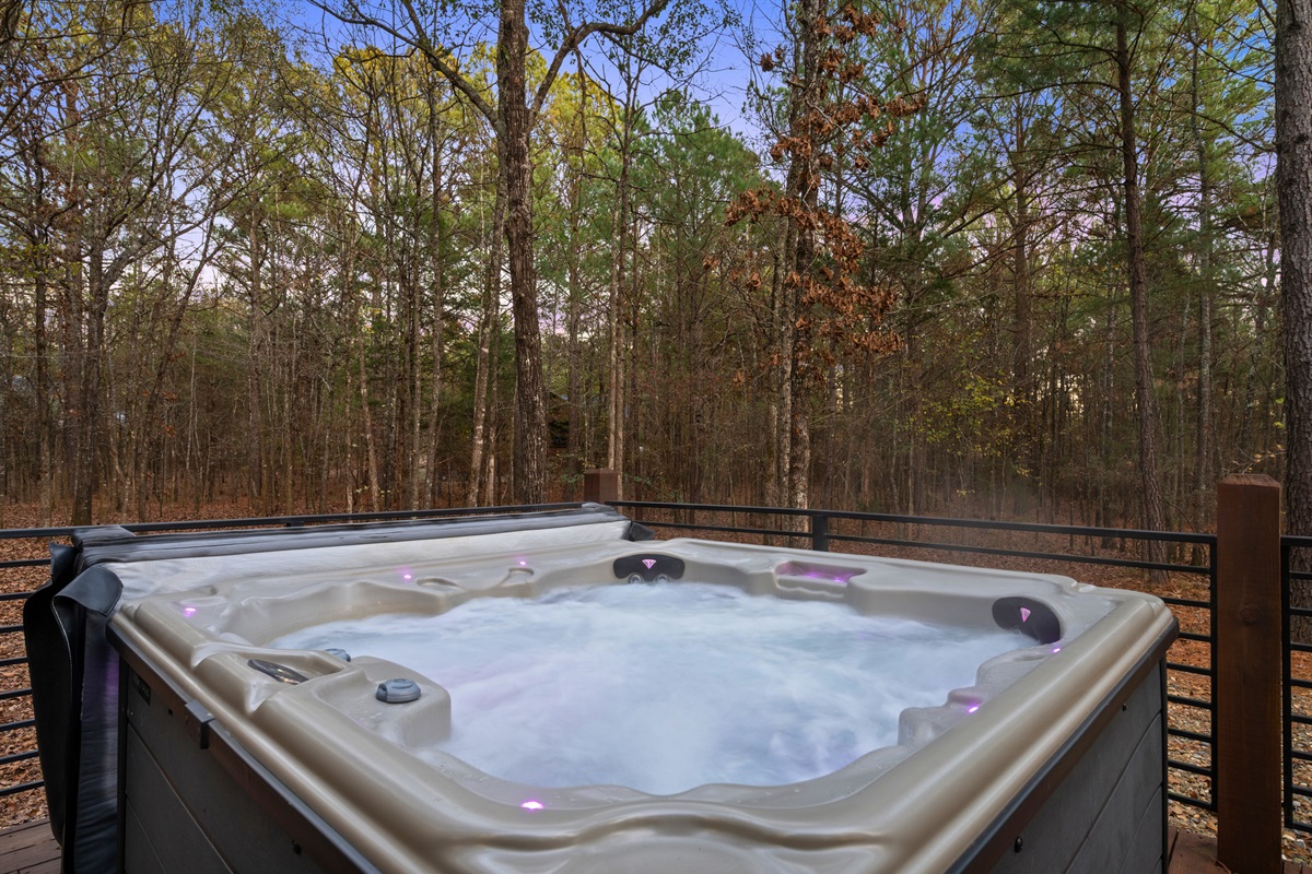 Tucked into the deck, the hot tub offers a relaxing place to unwind while listening to the sounds of the forest.