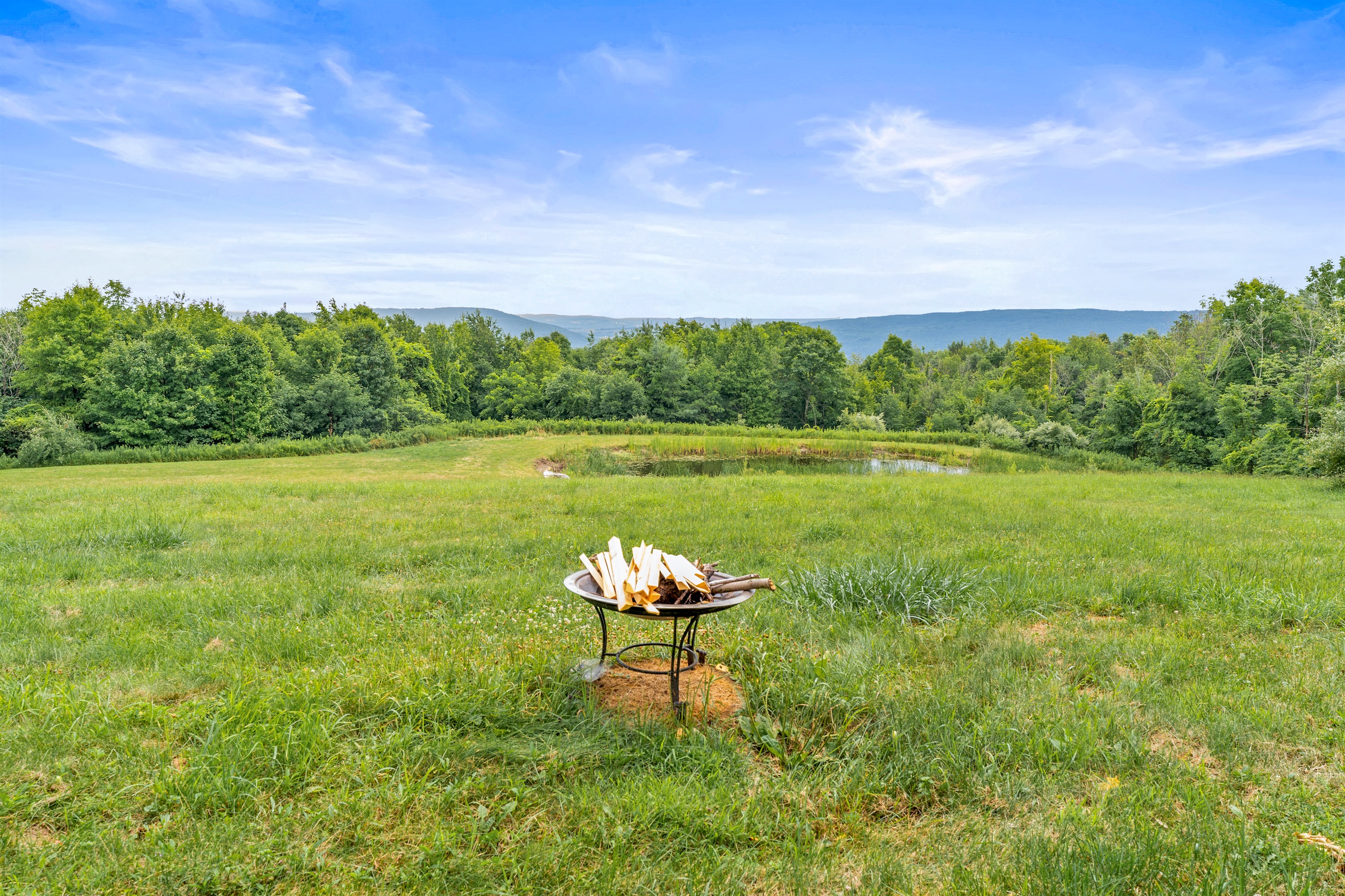 Gather around the fire pit and take in the incredible mountain views and peaceful pond setting