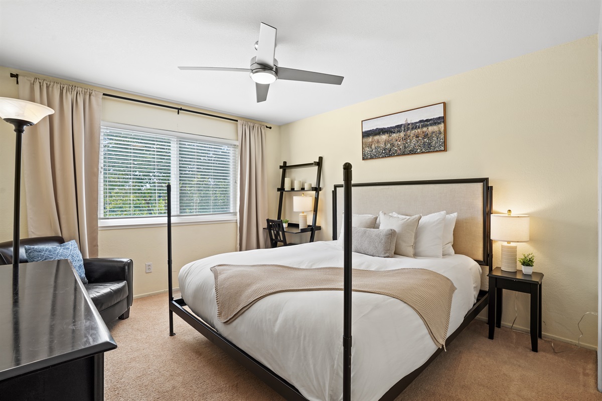 Relax and recharge in this cozy guest bedroom featuring a comfortable queen bed and calming, modern touches.