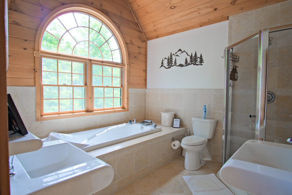 The master bathroom features a jet tub and separate shower, with 2 separate sinks.