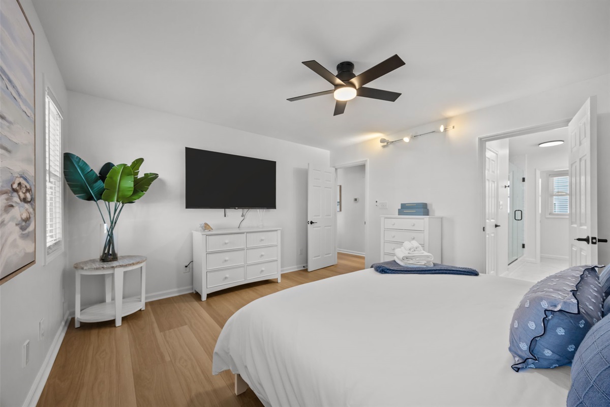 Spacious 1st floor master bedroom with comfortable king bed and modern coastal decor