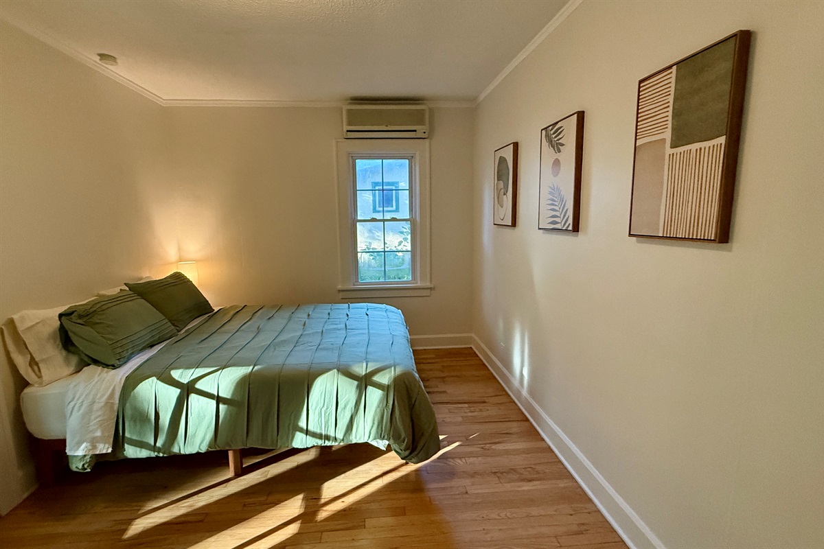 Bedrooms are furnished with a plush Queen bed, large dresser, a closet with hangers, and side tables with charging lamps.