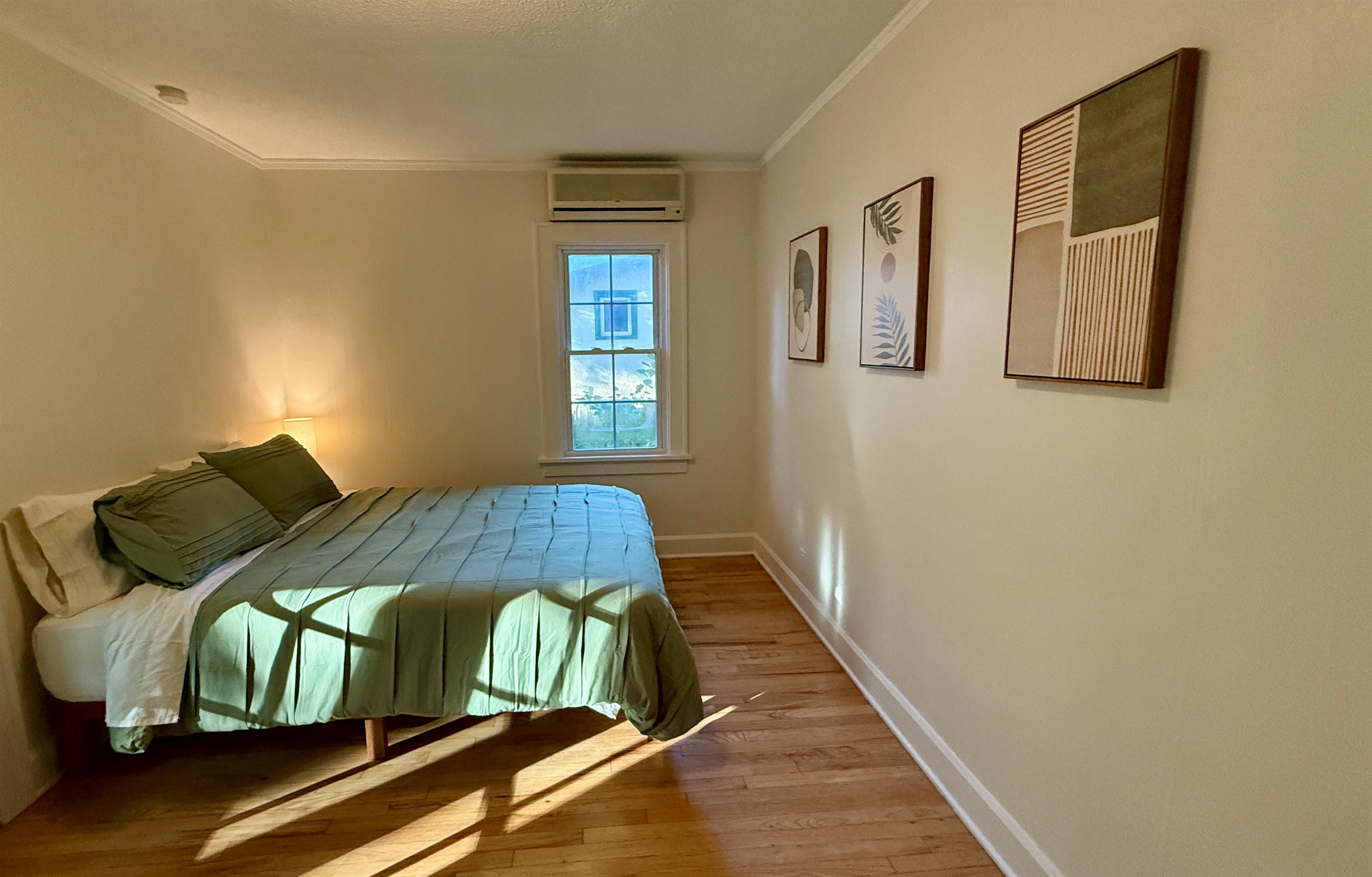 Bedrooms are furnished with a plush Queen bed, large dresser, a closet with hangers, and side tables with charging lamps.