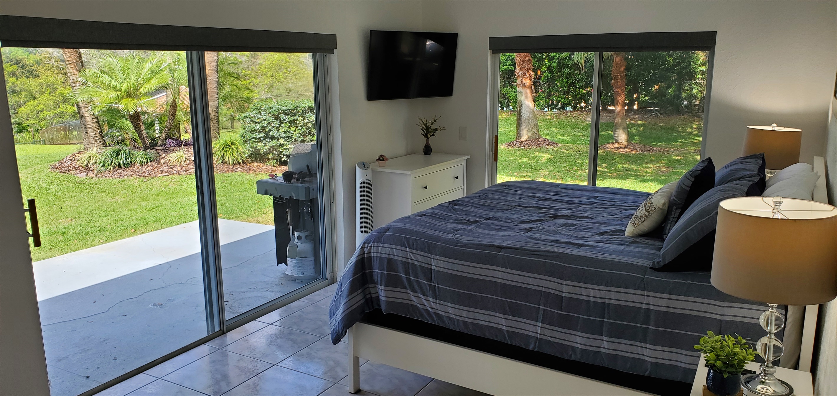 King bedroom with smart TV and backyard access