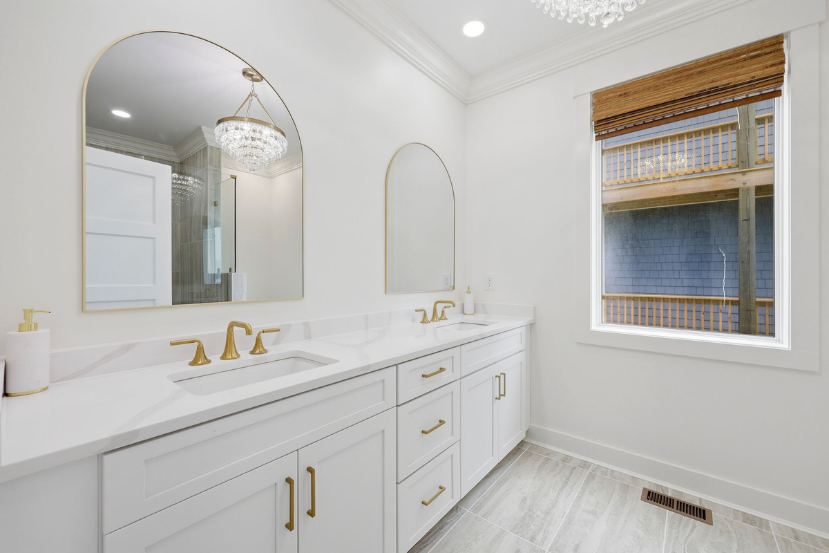 Second-floor king master bathroom with double vanity and modern coastal design