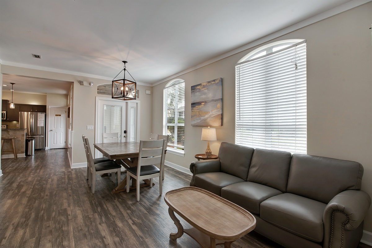  Living and dining spaces with warm wood flooring and bright windows