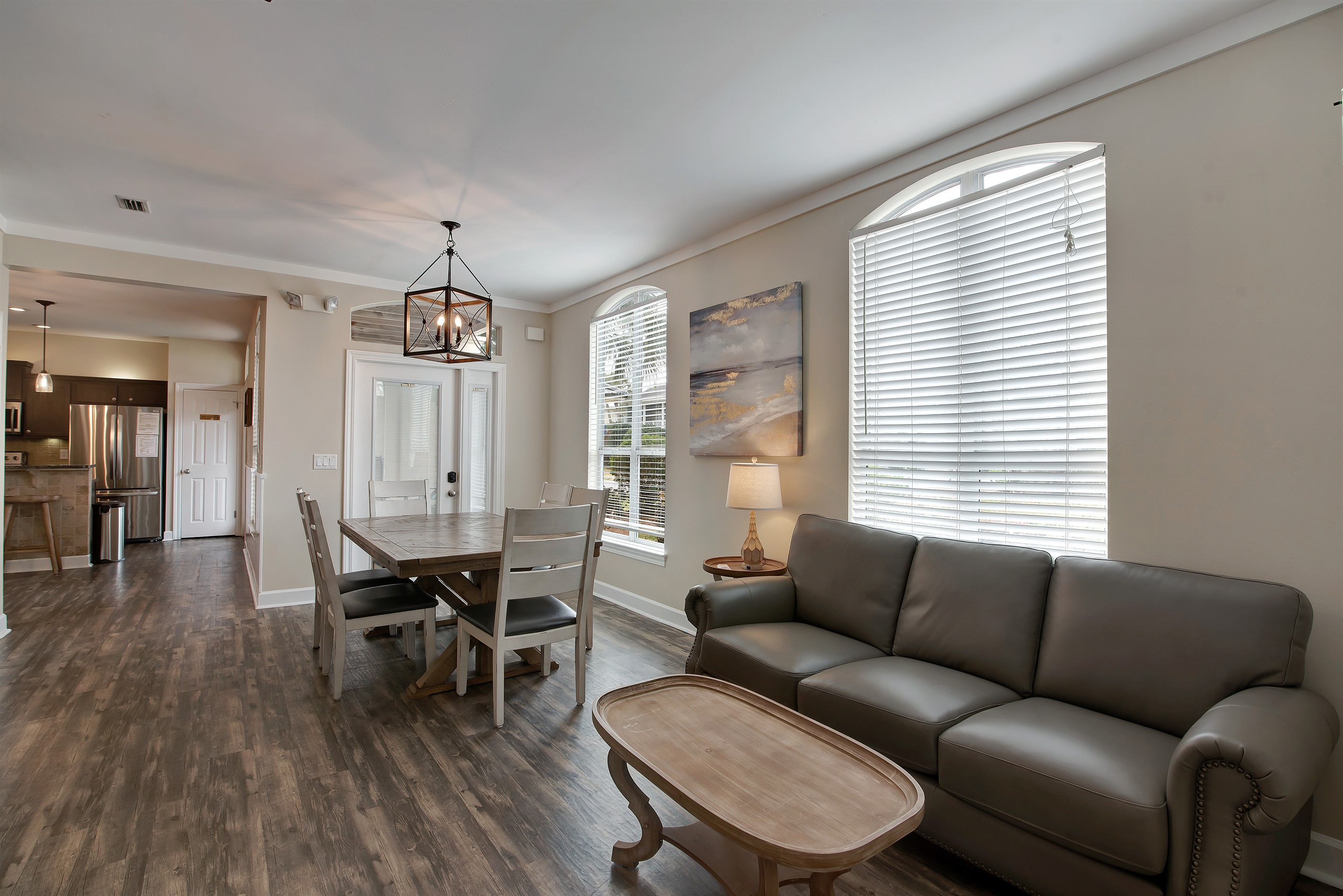  Living and dining spaces with warm wood flooring and bright windows