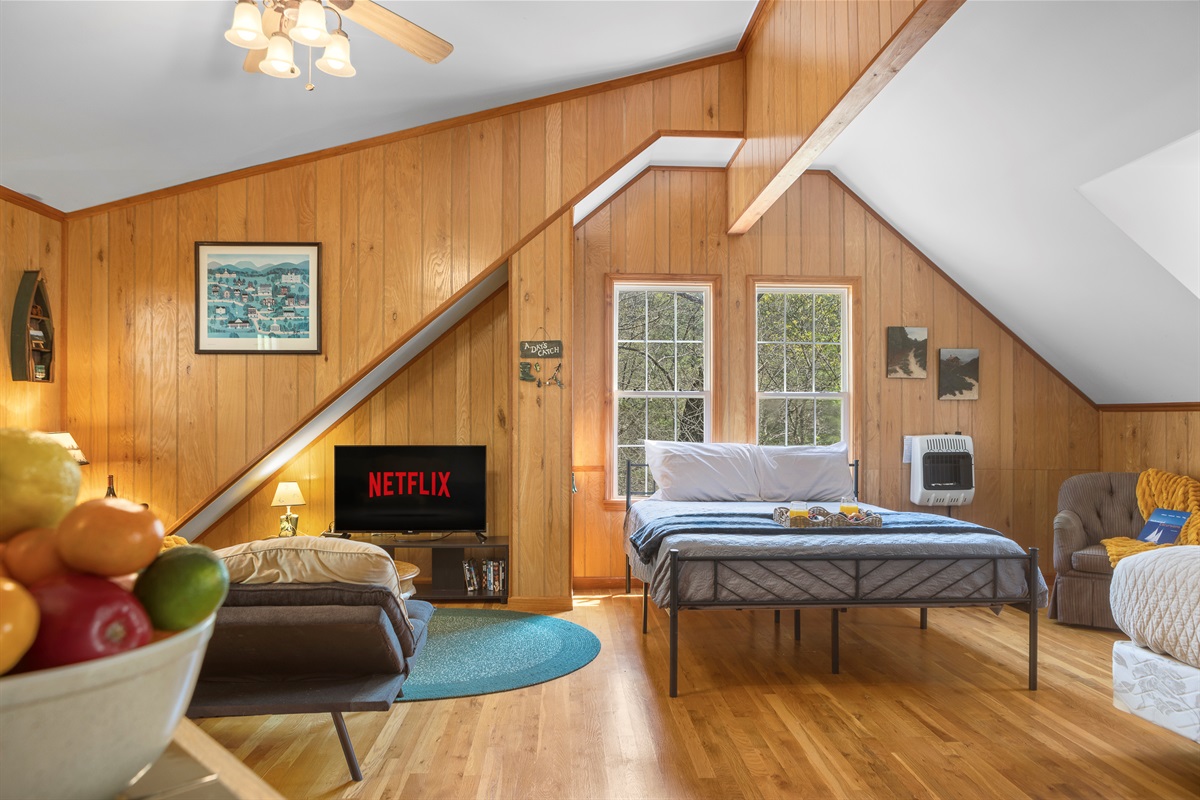 Queen Bedroom 3: Enjoy stunning woods views from this inviting room with Netflix access!