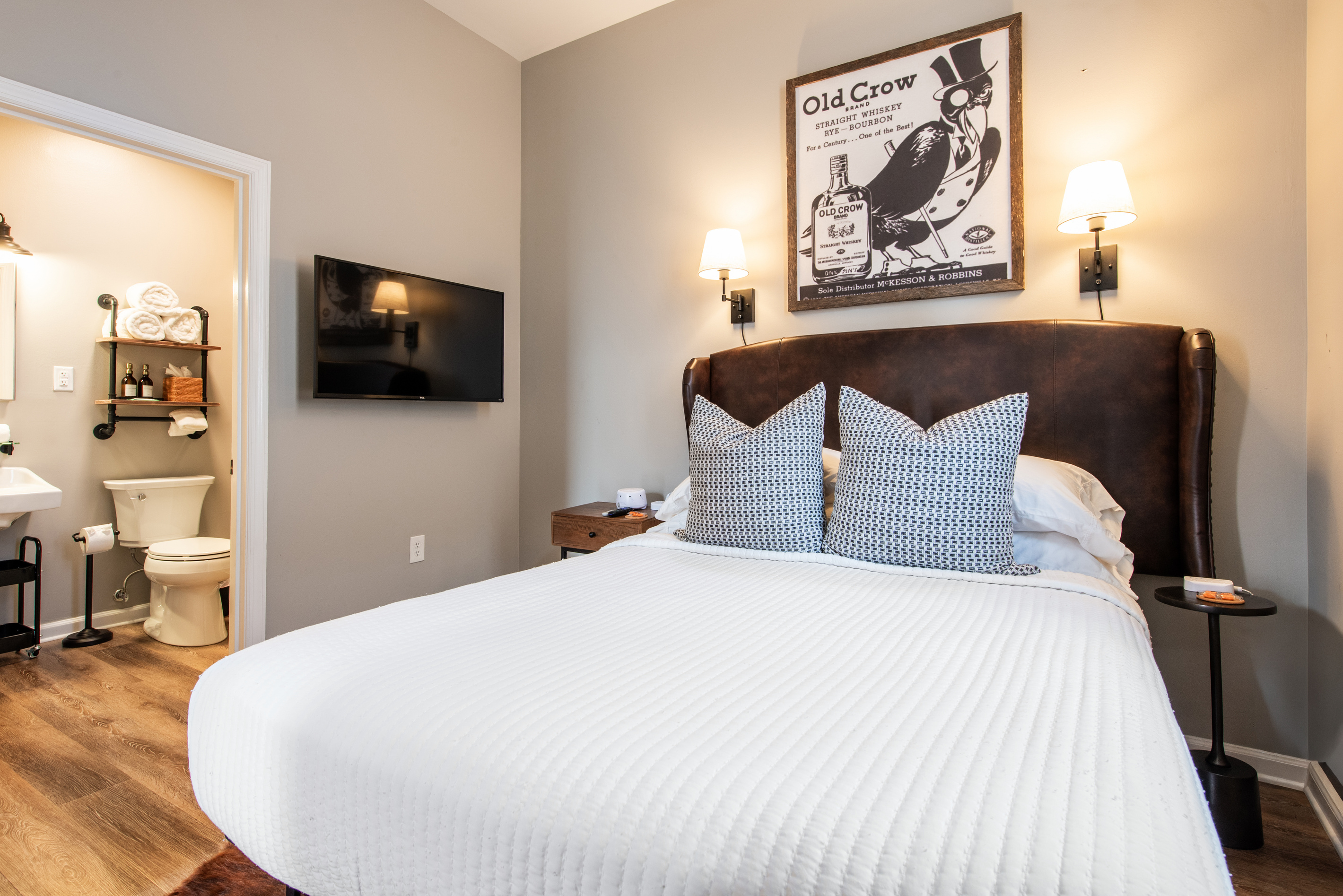The bedroom, with its television and adjoining bathroom visible.
